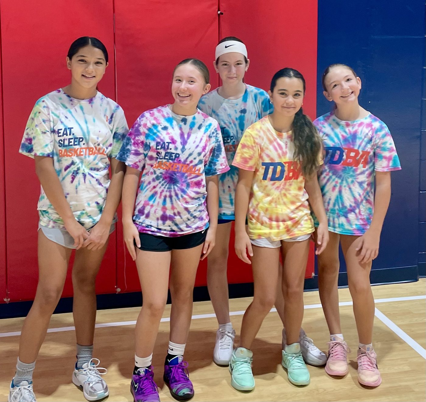 Older girls at a TDBA camp together in tie-dye TDBA shirts